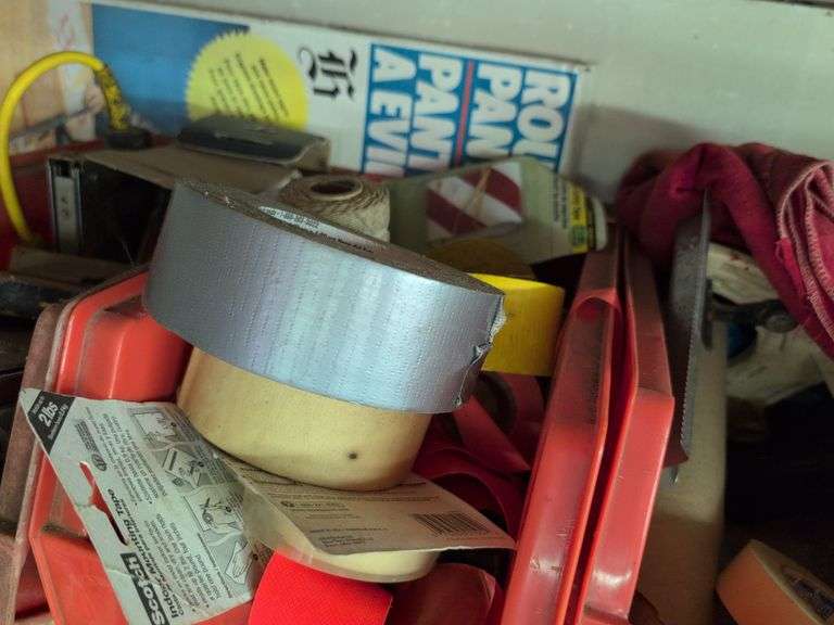 Contents of shelf - staple guns, tape, paint brushes, and more