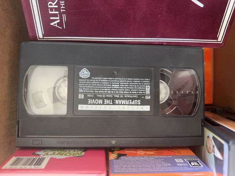 Box of VCR Tapes and DVDs