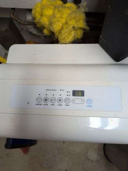 Contents of corner - dehumidifier, hard hat, cleaning items, and more