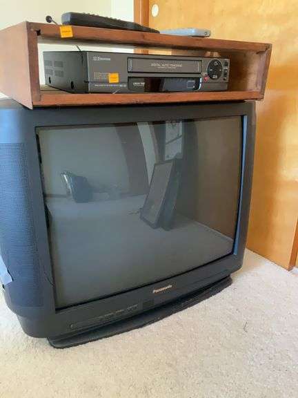 Panasonic 27” Colored Television, Emerson Video Cassette Player, Mounting Box