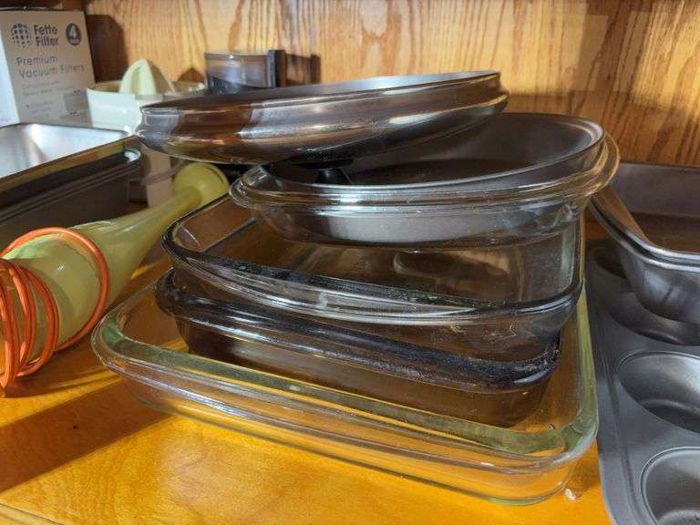 (2) shelves of stainless steel mixing bowls, cake pans, cupcake pan, loaf pans, and more