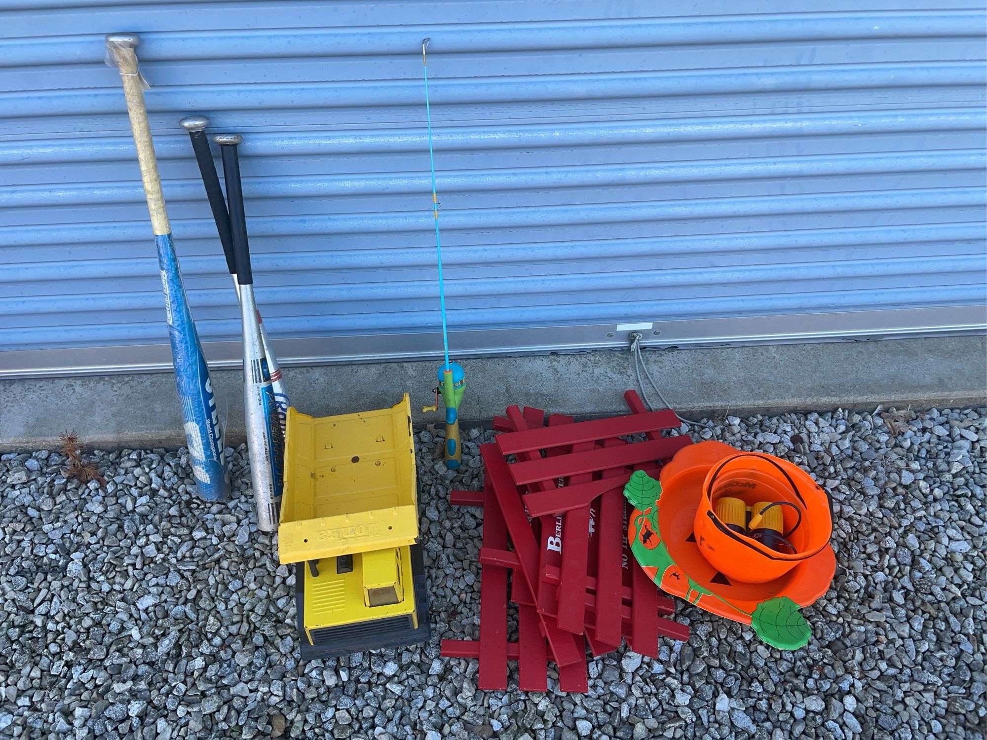 Tonka metal dump truck, (3) aluminum bats, Berlin Flyer wagon rails and misc.