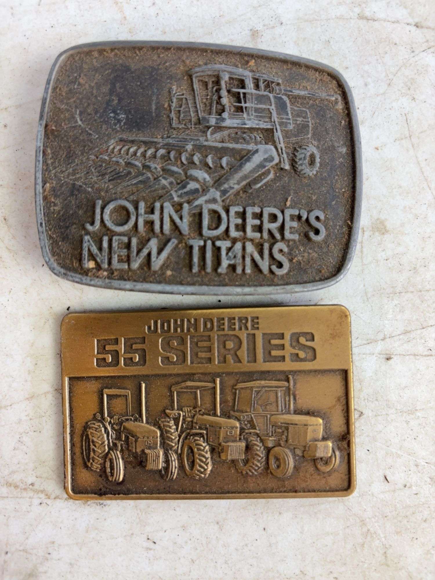 (6) John Deere belt buckles and (2) holiday coins
