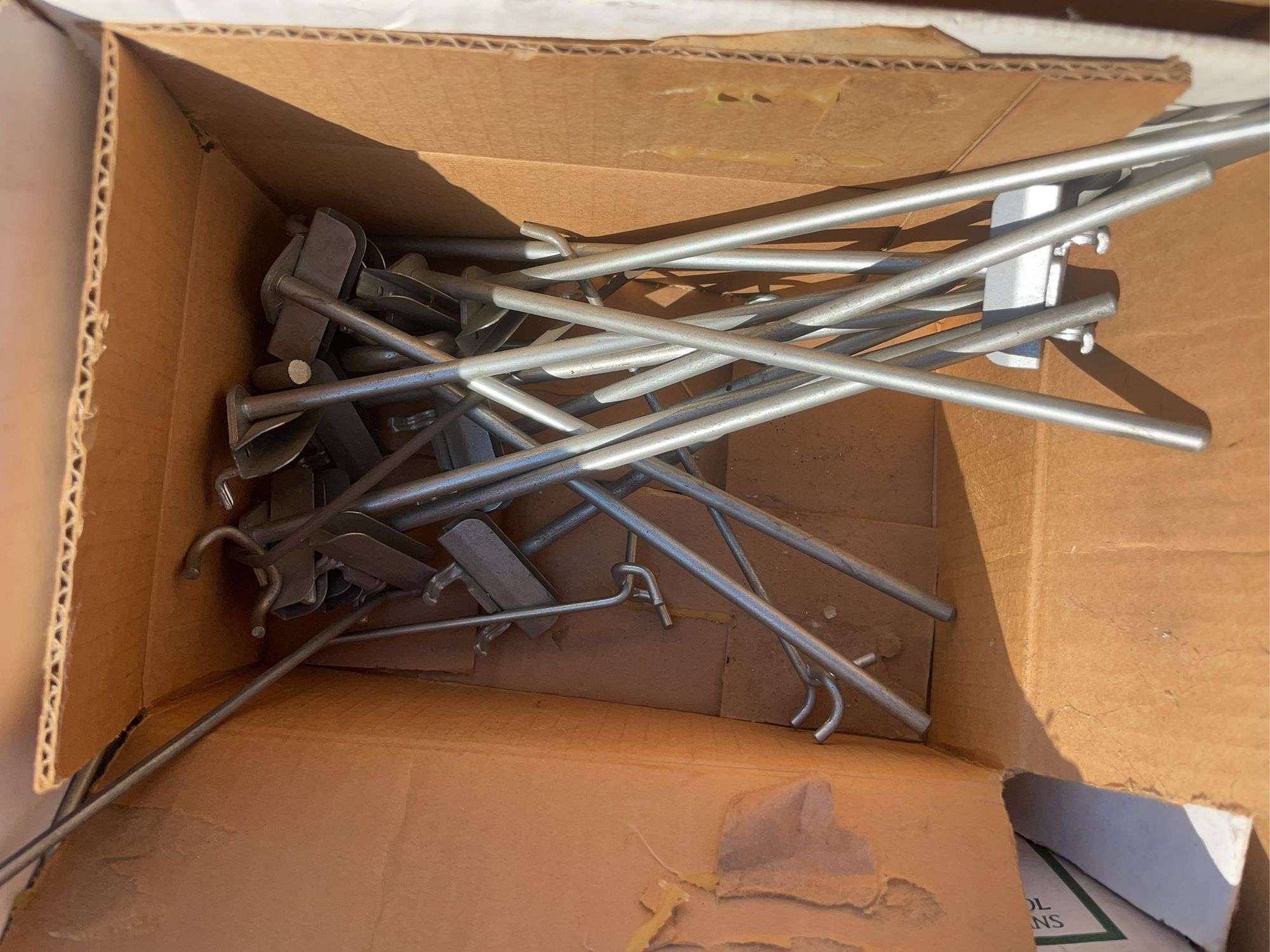 (2) boxes of hooks/shelving, mechanics chair and cord wheel
