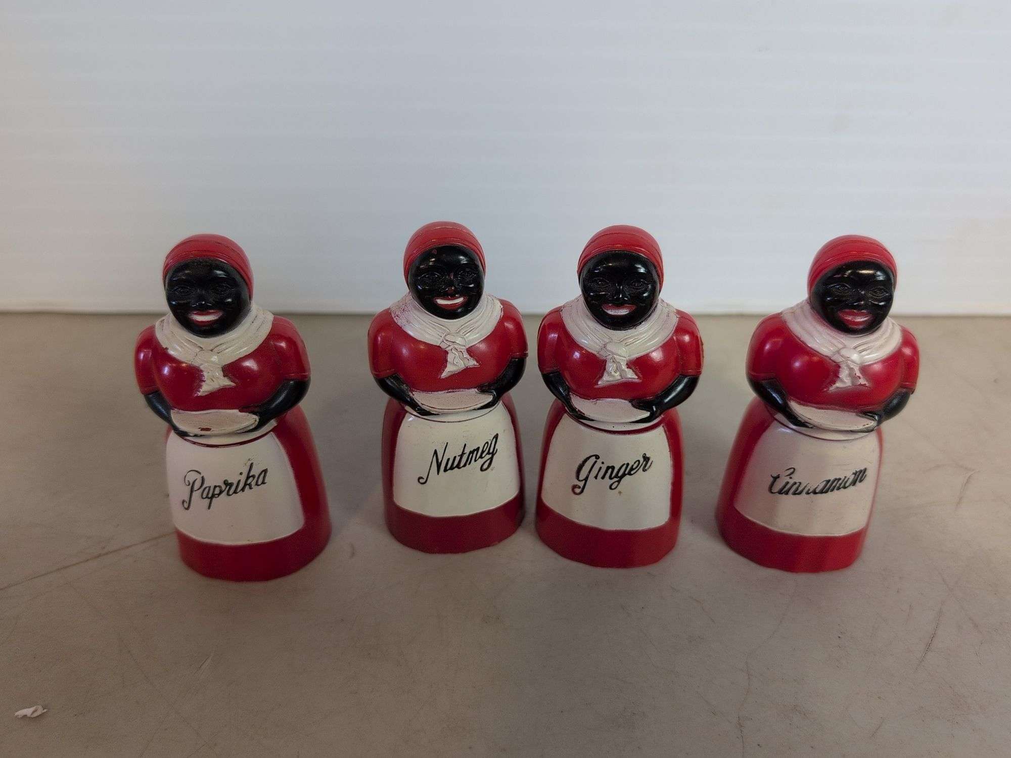 (4) plastic black Americana spice containers