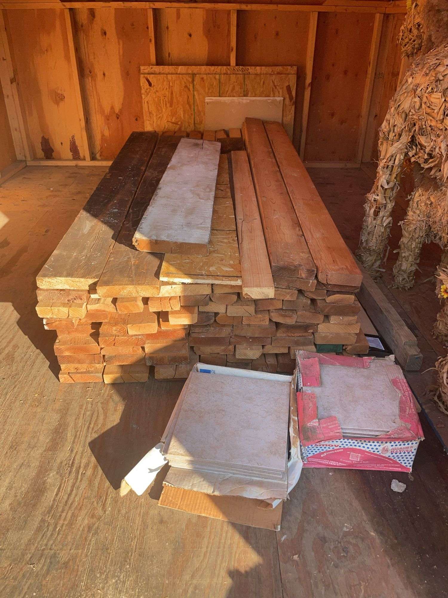 Large pile of wood and misc. tile flooring
