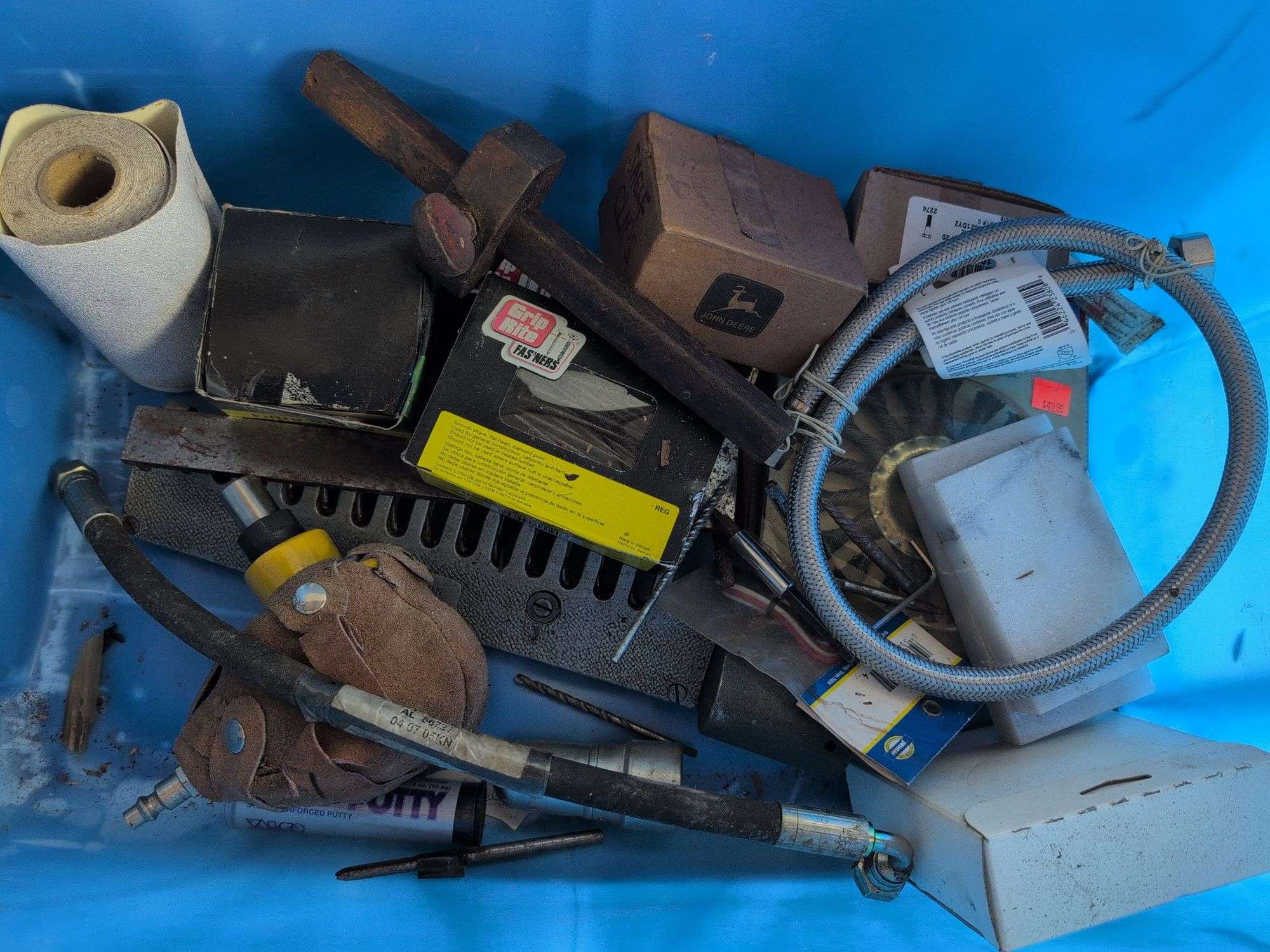 Tote with various tools - extension cord, level, bits, saw, and more