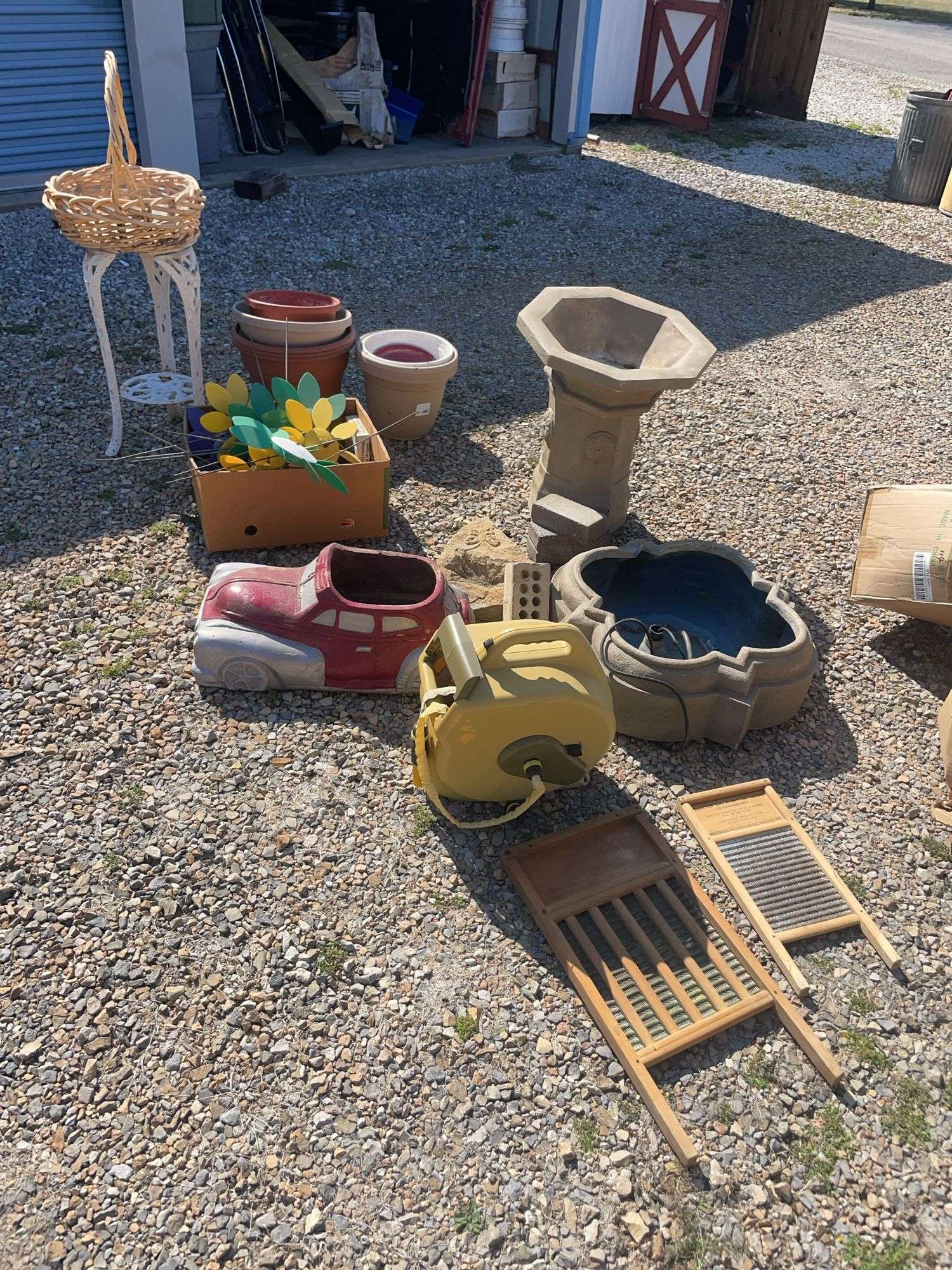Large lot of outdoor items including fountains, garden hose with reel, plant stand, basket, planters
