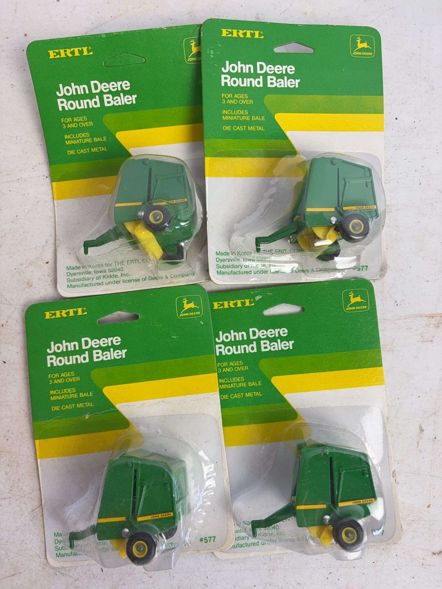(7) John Deere diecast model toys - (3) forage wagons and (4) round balers