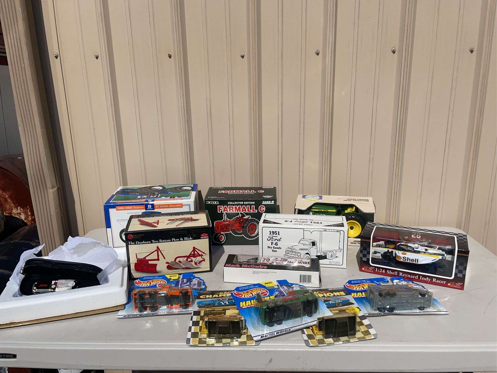 Box of toy tractors/cars/trucks and Ford pocketknife