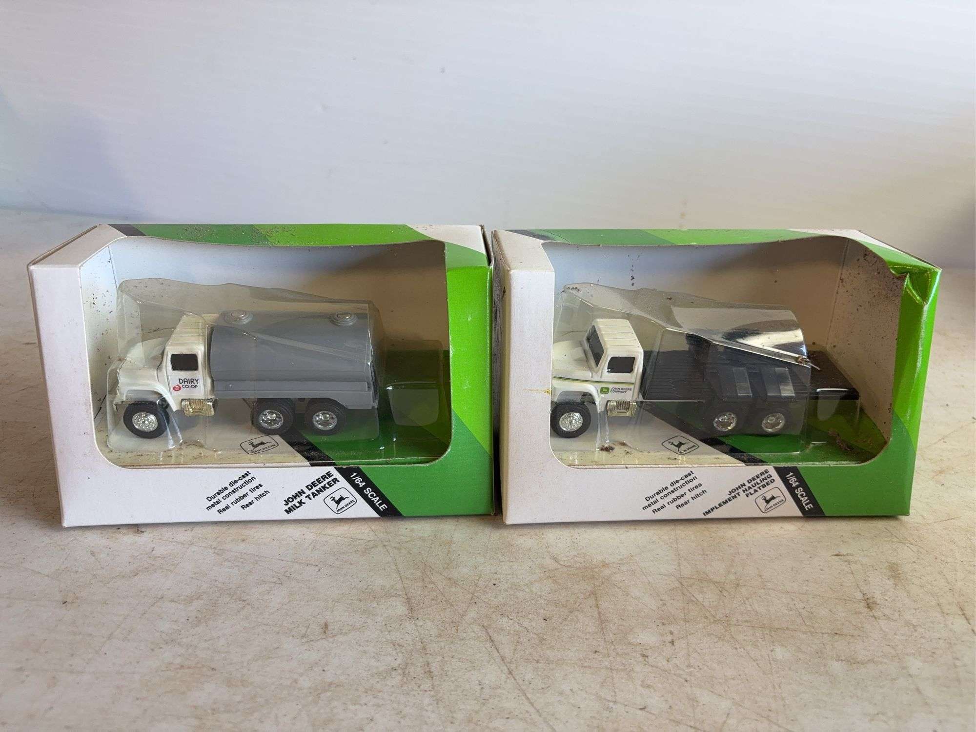 John Deere model milk tanker & John Deere model implement hauling flatbed - 1/64 scale, dirty