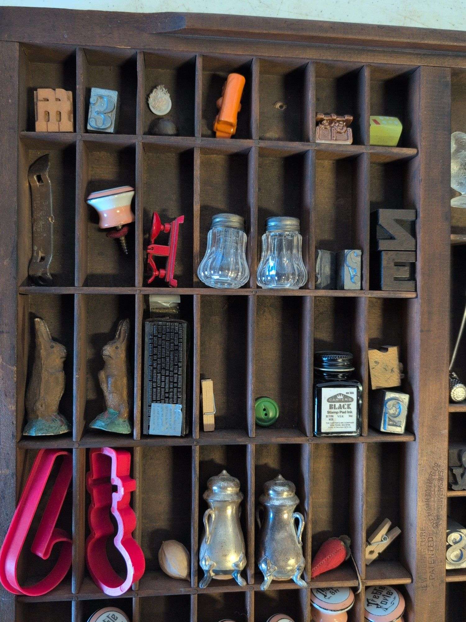 Shadow box with various vintage items - glass figures, print type blocks, and more