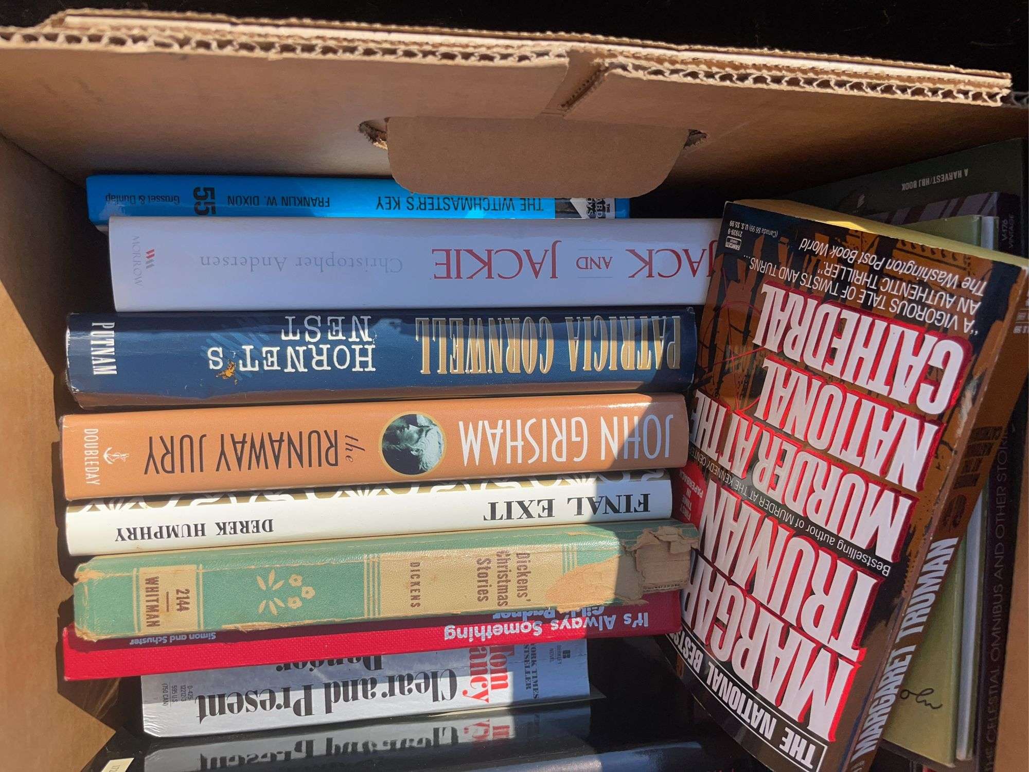 Box of books including The Hardy Boys, John Grisham, Technical writing and more