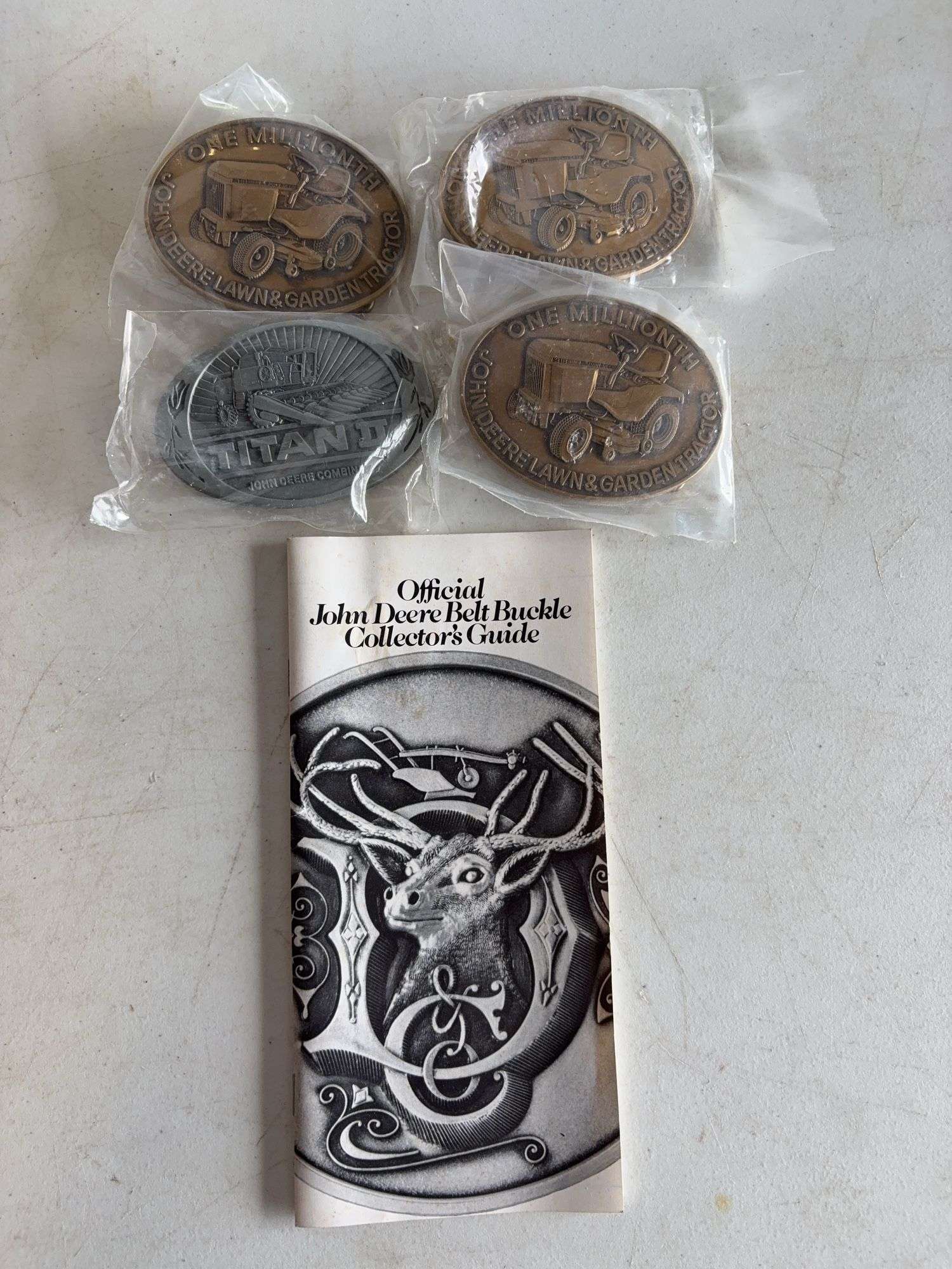 (4) John Deere belt buckles