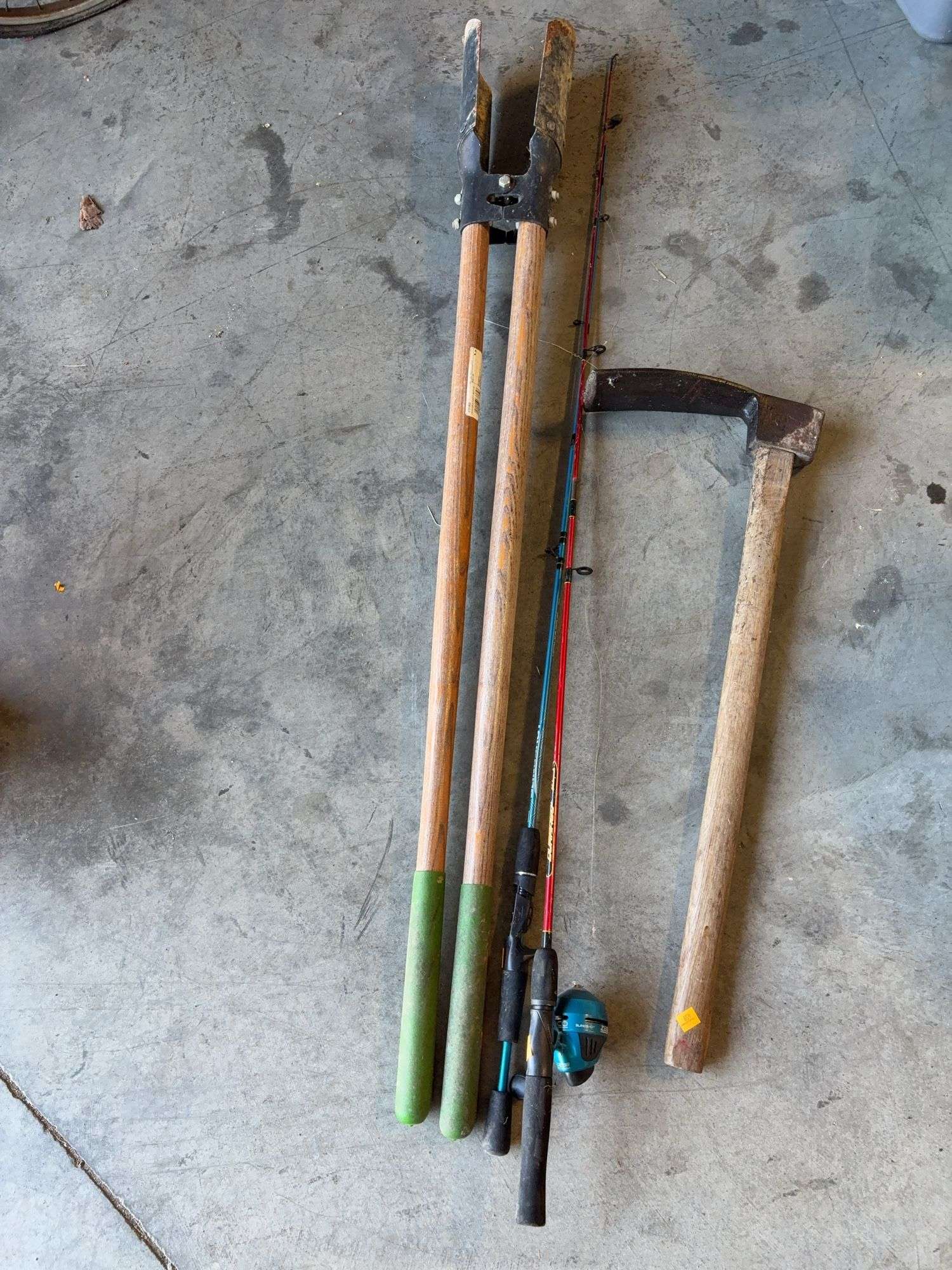 Post hole digger, adze, and (2) fishing poles