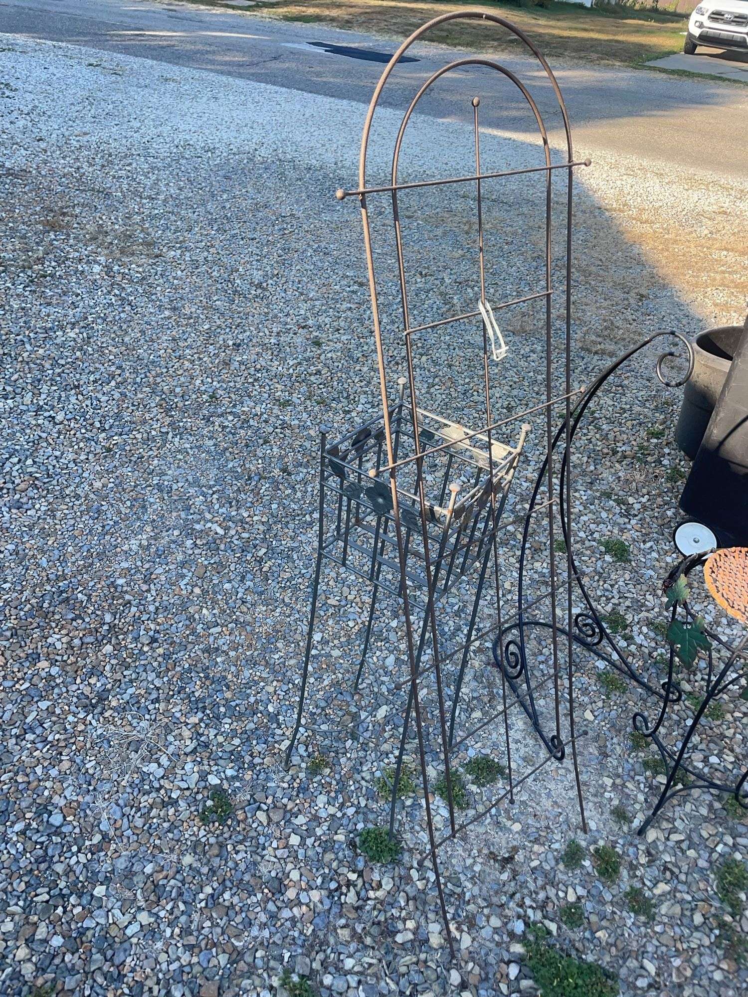 Assortment of garden decor/ plant stands, hanging basket hook and more