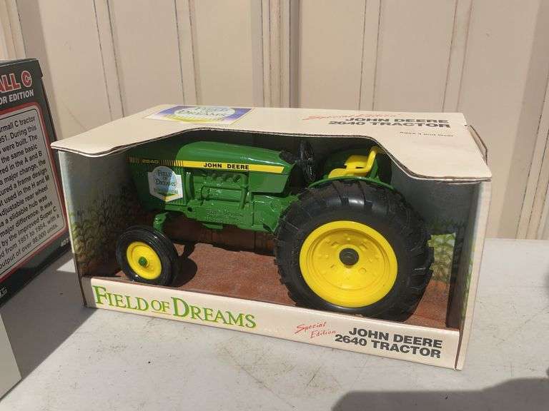 Box of toy tractors/cars/trucks and Ford pocketknife