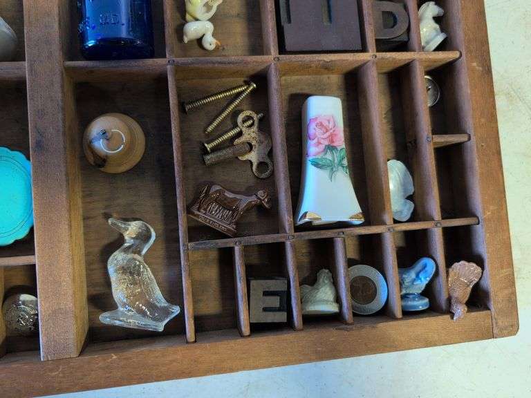 Shadow box with various vintage items - glass figurines, keys, pins, and more