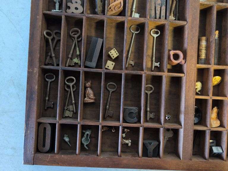 Shadow box with various vintage items - glass figurines, keys, pins, and more