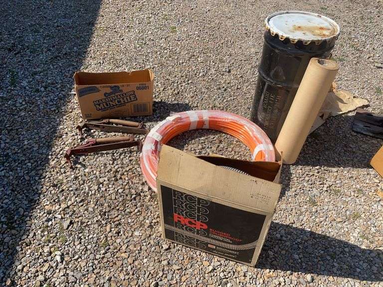 Metal drum, Pex tubing, vacuum hose and Fuller Brikarier brick carrier