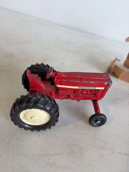 John Deere plate, die-cast model car, and International model tractor