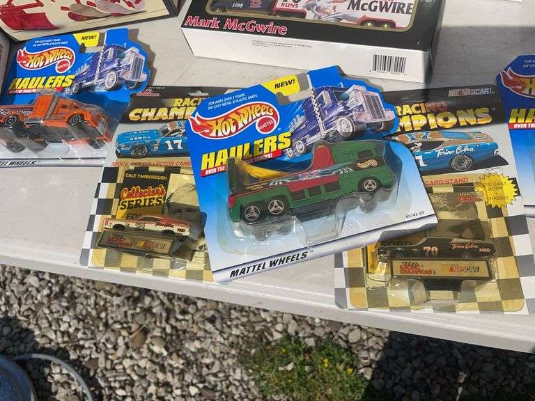 Box of toy tractors/cars/trucks and Ford pocketknife