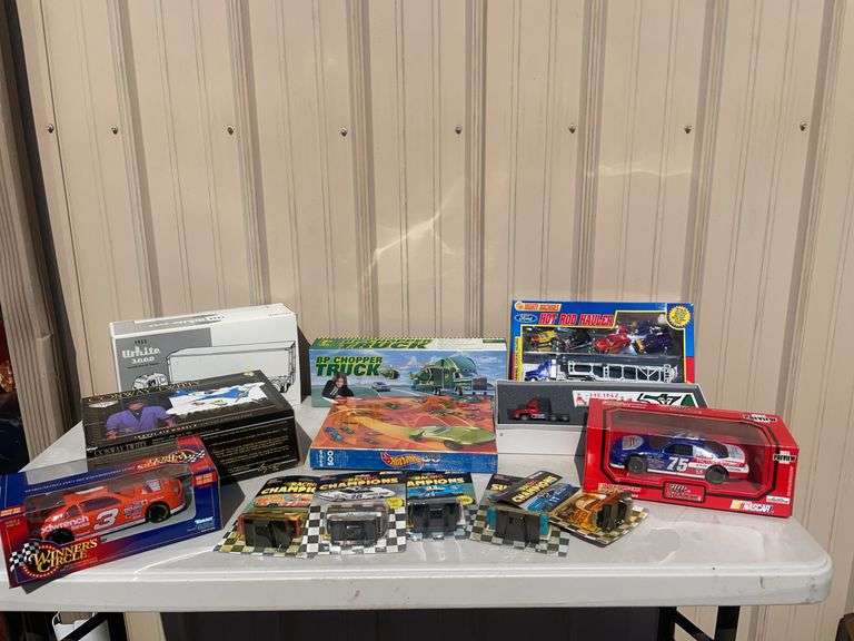 Box of mostly new cars/ toys including hot rod hauler, racing Champions car, BP Chopper Truck and mo