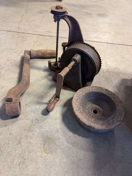 Wooden crate with antique tools - crank grinder, pulley, and more