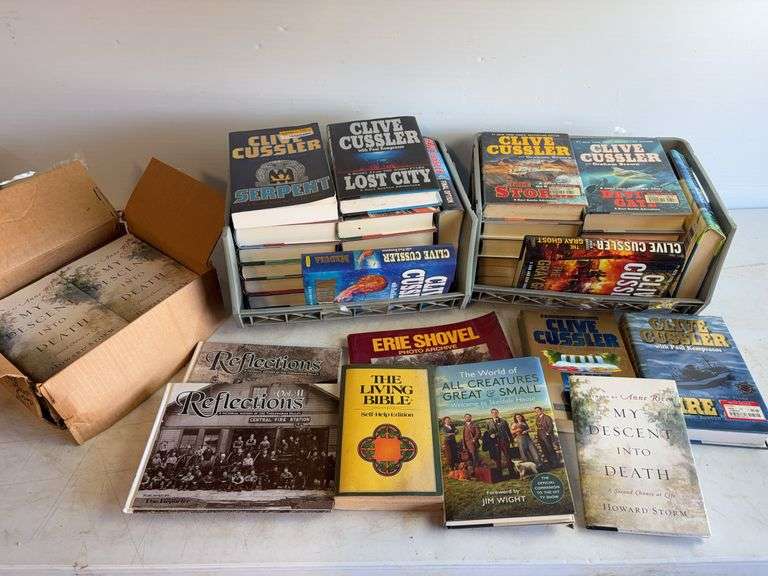 Large assortment of Clive Cussler books and other books