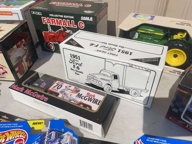 Box of toy tractors/cars/trucks and Ford pocketknife