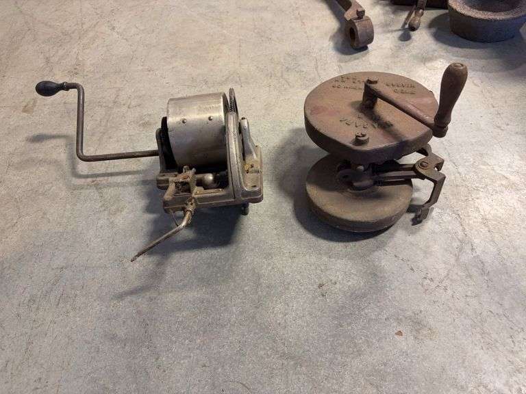 Wooden crate with antique tools - crank grinder, pulley, and more