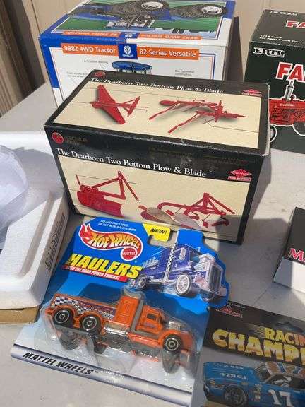Box of toy tractors/cars/trucks and Ford pocketknife