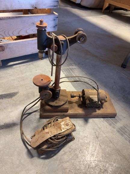 Wooden crate with antique tools - crank grinder, pulley, and more