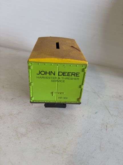 John Deere plate, die-cast model car, and International model tractor