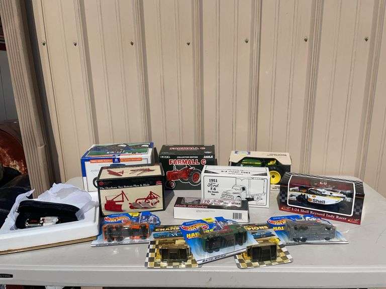 Box of toy tractors/cars/trucks and Ford pocketknife