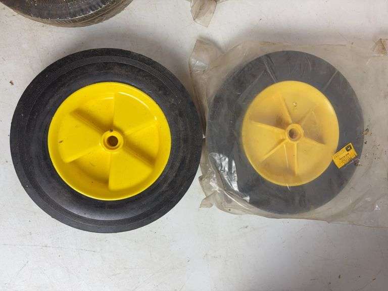 Miscellaneous John Deere items - (4) wheels, toy booklets, and more