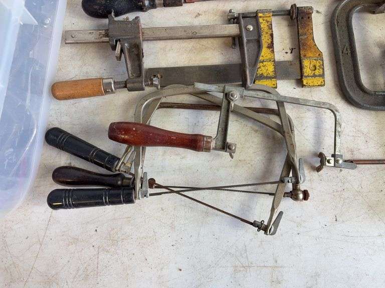Tote of hand saws and clamps