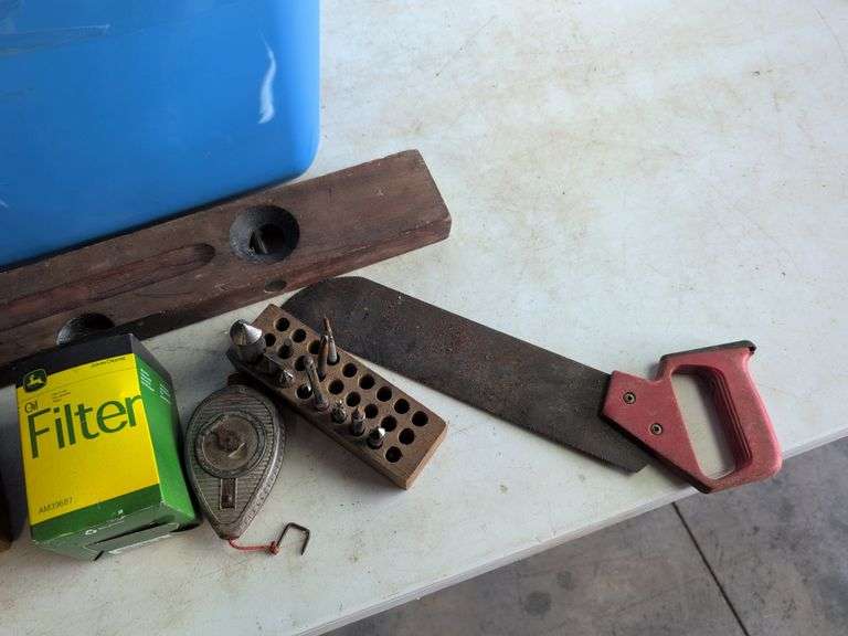 Tote with various tools - extension cord, level, bits, saw, and more