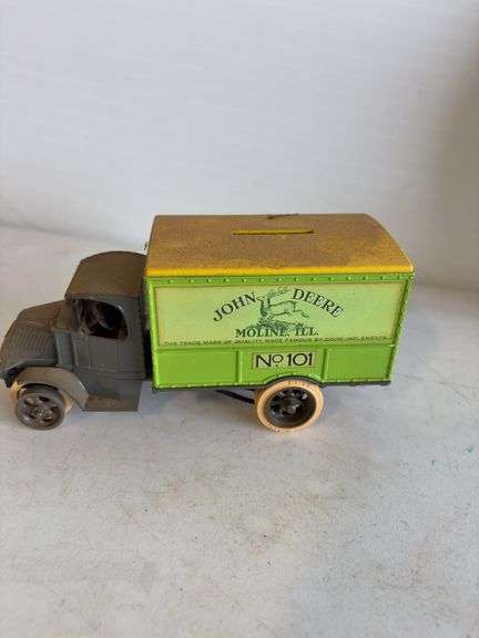 John Deere plate, die-cast model car, and International model tractor