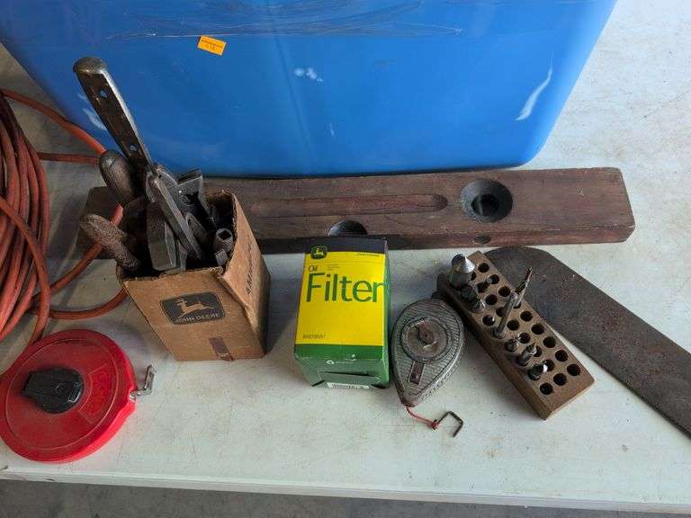 Tote with various tools - extension cord, level, bits, saw, and more