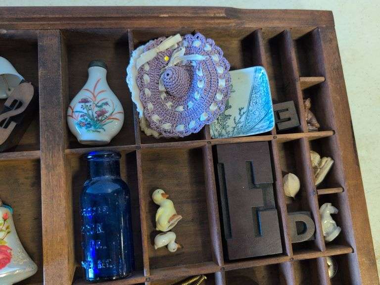 Shadow box with various vintage items - glass figurines, keys, pins, and more