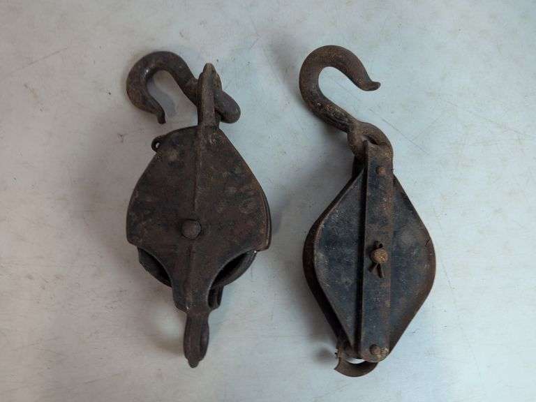 (2) antique metal pulleys