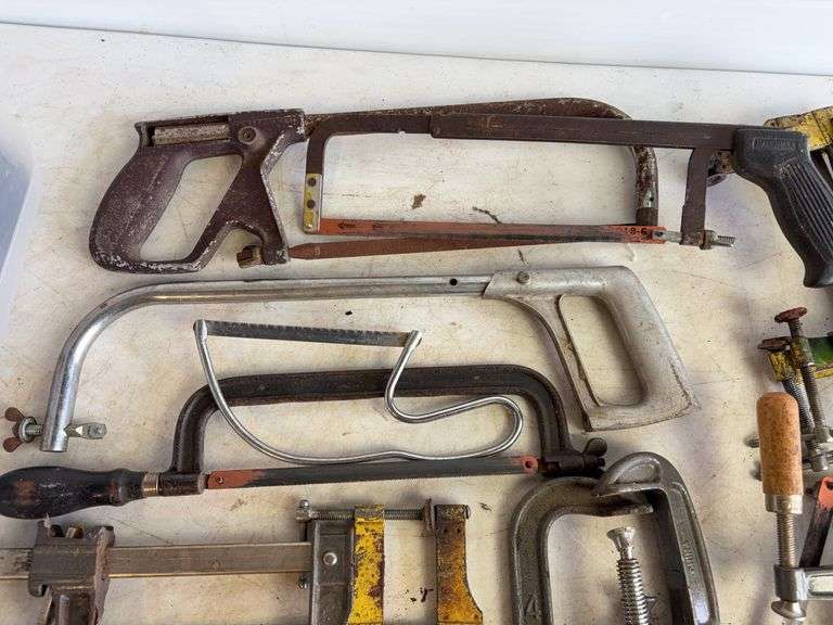 Tote of hand saws and clamps