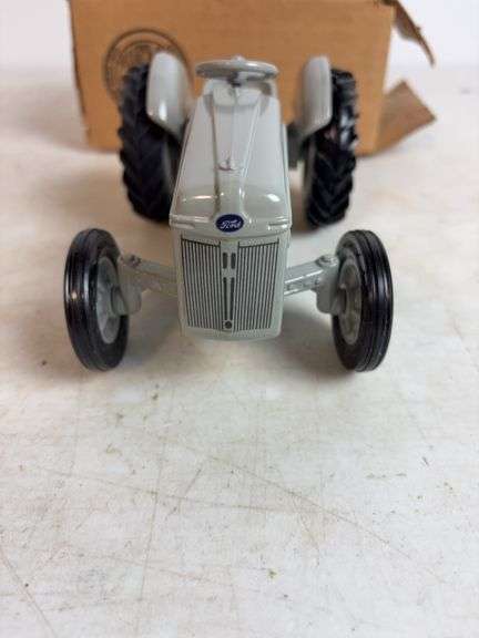 Ford 8N die-cast model tractor with Dearborn plow and other Ford tractor - 1/16 scale, dirty