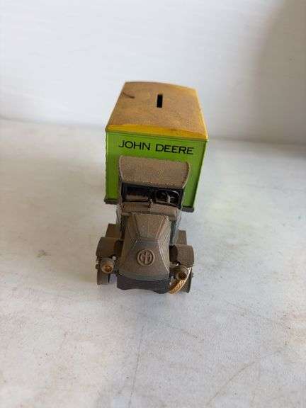 John Deere plate, die-cast model car, and International model tractor
