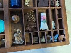 Shadow box with various vintage items - glass figurines, keys, pins, and more