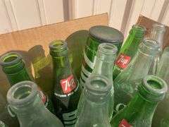Box of empty 7-up and Mountain Dew bottles