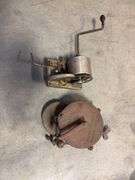 Wooden crate with antique tools - crank grinder, pulley, and more