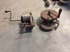 Wooden crate with antique tools - crank grinder, pulley, and more