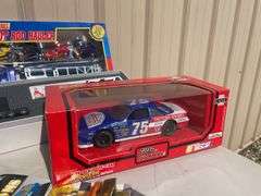 Box of mostly new cars/ toys including hot rod hauler, racing Champions car, BP Chopper Truck and mo